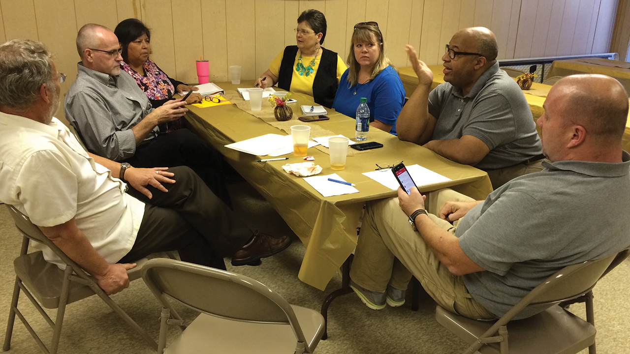 Roger Neufeld Smith, Mark and Carol Roth, Rhoda Yoder, Susan Nisly (former Service Adventure director), Pastor Horace McMillon and Pastor Hugh Hollowell at a Service Adventure leadership meeting at Open Door Mennonite Church in 2018. — Cynthia Neufeld Smith