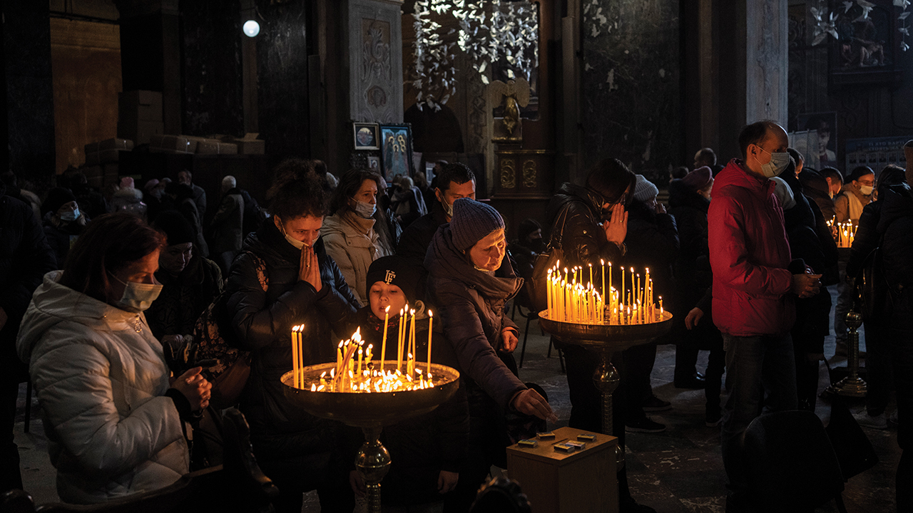 Worshipers pray for peace during a Sunday mass in the Saints Peter and Paul Garrison Church in Lviv, Ukraine, on March 6. — Bernat Armangue/AP