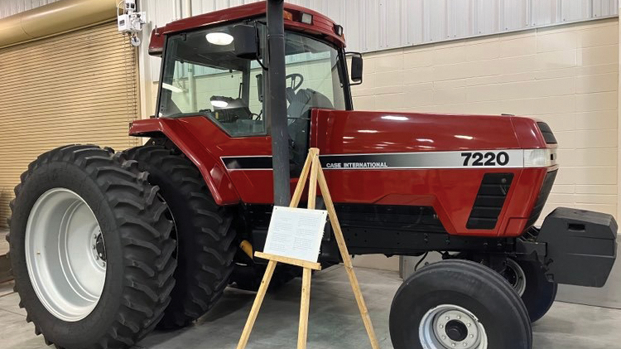 The family of Elmer Friesen donated this tractor, which sold for $76,000, to the Kansas Mennonite Relief Sale. Below: Volunteer Jerry Toews with a 1938 Ford Deluxe, which fetched $15,750. — Paul Schrag/Anabaptist World