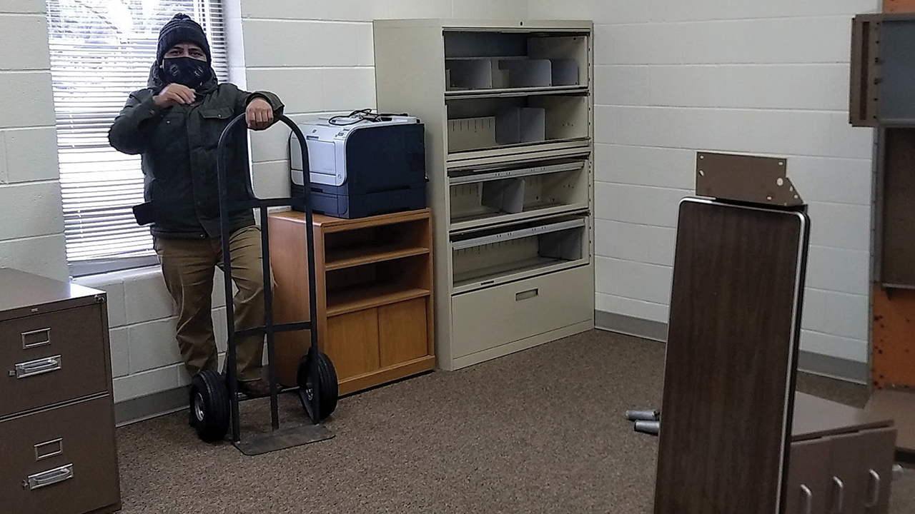 Naun Cerrato unloads office equipment for the office of La Posada at Sunnyside Mennonite Church in Elkhart, Ind. — La Posada
