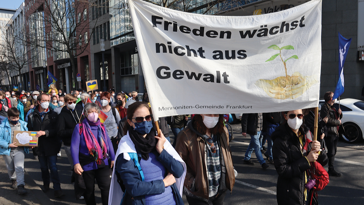 Members of Frankfurt Mennonite Church carry a banner during a peace rally March 13 in Frankfurt, Germany. The banner proclaims, “Peace does not grow from violence.” — Ulrich Leutbecher