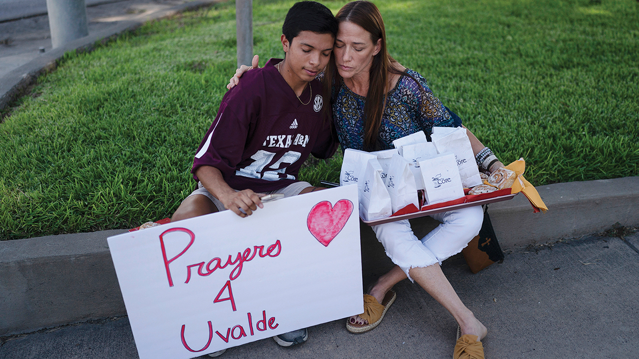 Diego Esquivel, left, and Linda Klaasson comfort each other May 25 as they gather to honor the victims killed in the shooting at Robb Elementary School in Uvalde, Texas. — Jae C. Hong/AP