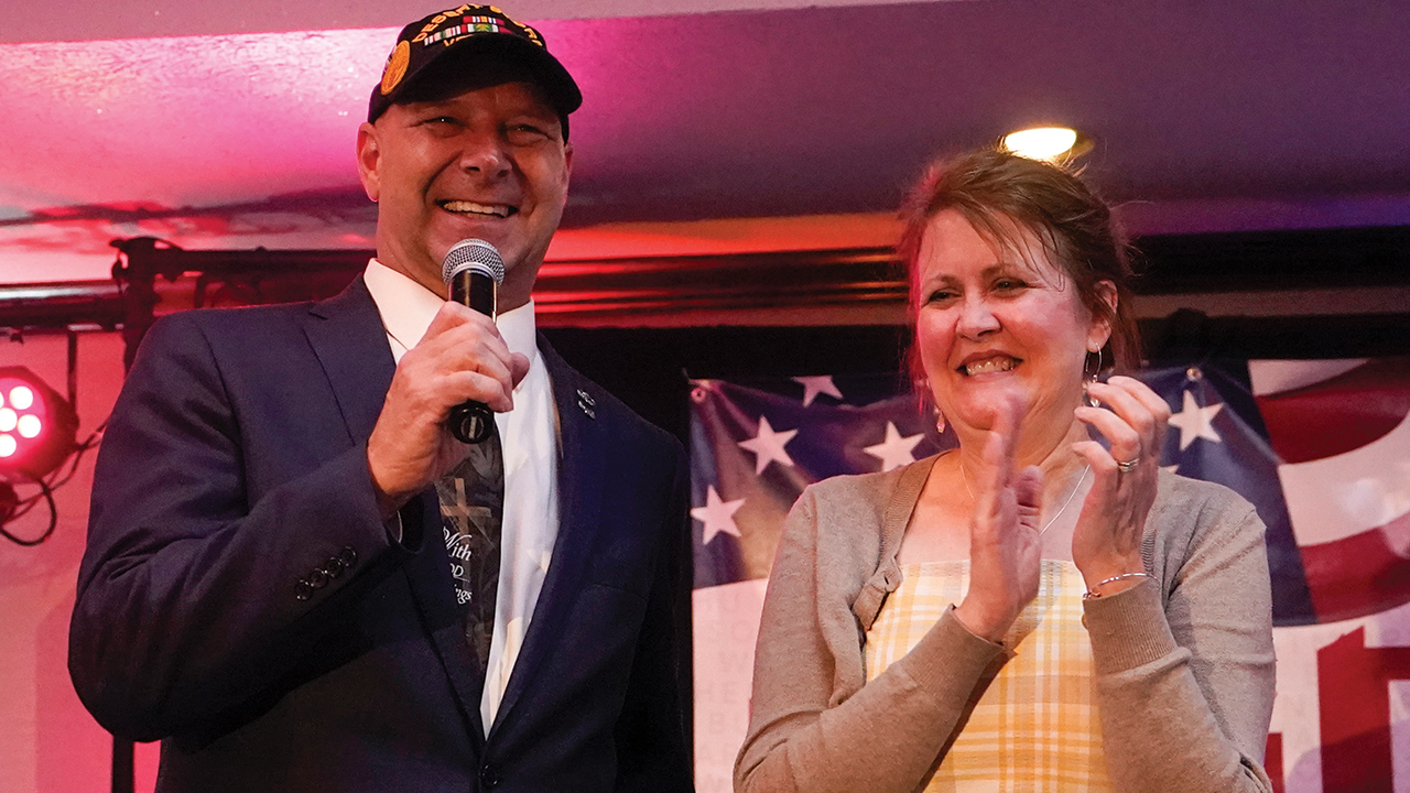 Doug Mastriano, Republican candidate for governor of Pennsylvania, with his wife, Rebecca, on May 17 at a primary night election gathering in Chambersburg. He is wearing a Desert Storm veterans hat, and his tie says, “With God all things are possible.” — Carolyn Kaster/AP
