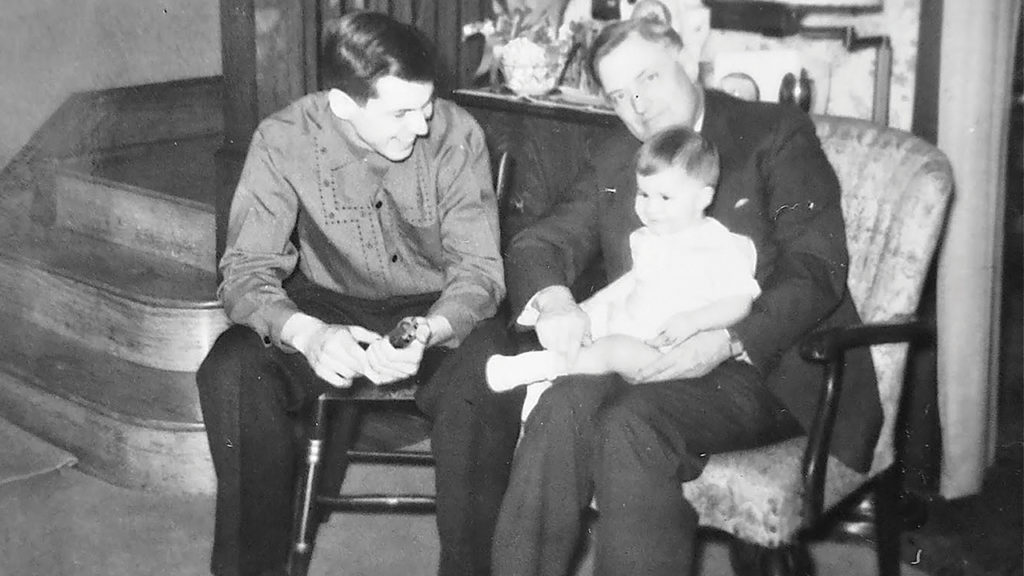 John Paul Lederach, on grandfather Willis K. Lederach’s lap, with father John M. Lederach looking on, in 1955. — John Paul Lederach
