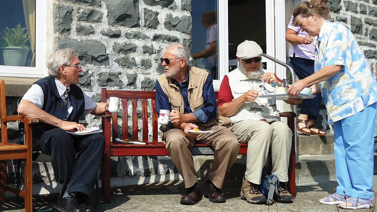 As co-leader of a Celtic pilgrimage in 2010, Willard E. Roth, left, relaxes for afternoon tea with pilgrims and hosts at St. Non’s retreat at St. Davids on the west coast of Wales. Saint David, patron saint of Wales, was born about A.D. 500 on the grounds of St. Non’s. — Willard E. Roth