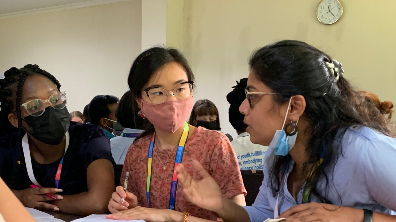 Mlobane Ntandoyenkosi of South Africa, left, and Christen Kong of Canada, center, listen as Akansha Milap of India speaks during a Global Youth Summit delegate session. — Aaron Epp/Meetinghouse