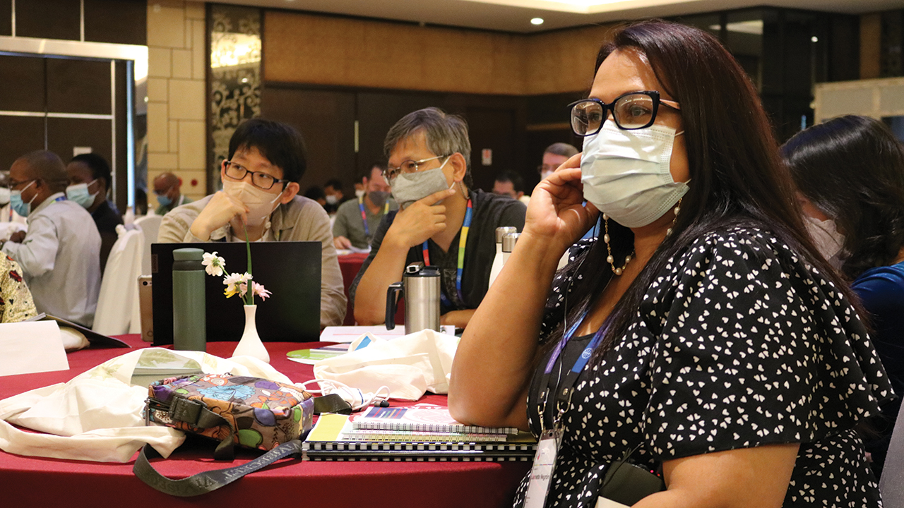 Jannette Negrón Concepción, leader of Convención de las Iglesias Menonitas de Puerto Rico, listens to interpretation at the MWC General Council meeting in Salatiga, Indonesia. — Karla Braun/MWC