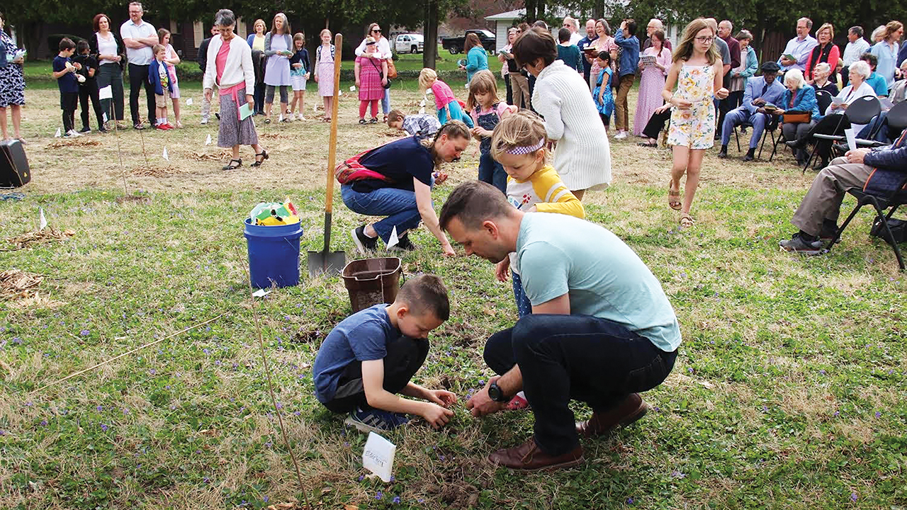 Members of Berkey Avenue Mennonite Fellowship plant trees on Good Friday. — Phil Bauman