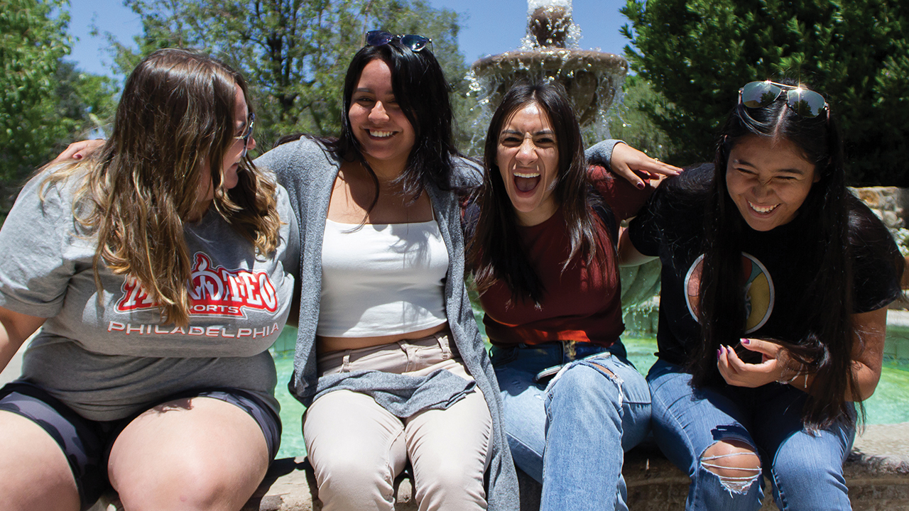 Alecia Espinosa, Karina Morales, Sarai Uriostegui and Betsy Olvera, participants in the Multicultural Peace Collaboration learning tour, sit at the fountain that is part of the Cesar E. Chavez National Monument, southeast of Bakersfield, Calif. Chavez was an advocate for migrant farmers’ rights. — Jessica Chisolm/MCC