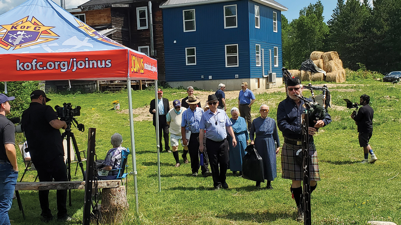 Bagpiper Donald Macdonald leads a procession of representatives from Mennonite Disaster Service and the Knights of Columbus to the dedication of the Jobin family’s house addition. — Mennonite Disaster Service