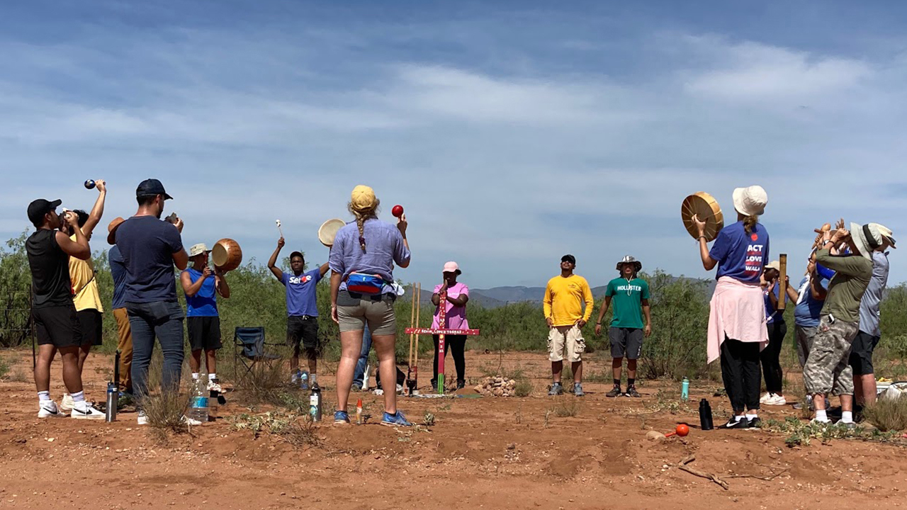 Young adults in the Youth Venture Immigration and Borderlands Learning Tour take part in a cross-planting ceremony July 19 in memory of Kevin Lopez Torres, who died of thirst earlier this year while attempting to cross the desert. Later that evening, the group participated in a prayer vigil recognizing the thousands of migrants who have died in the desert. — Mennonite Mission Network
