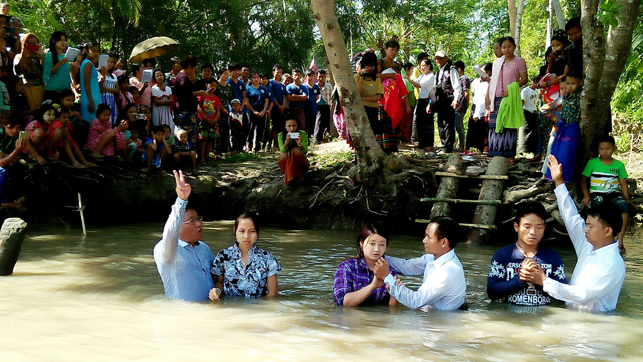 Amos Chin, left, and two Mennonite colleagues baptize young people in rural Myanmar. — Amos Chin
