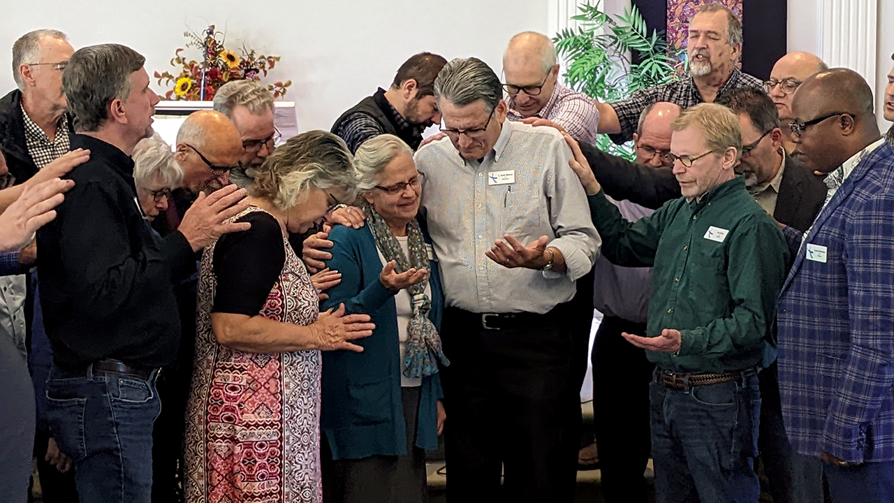 LMC pastors pray over retiring moderator L. Keith Weaver and his wife, JoAnne, on Sept. 24 at LMC’s Fall Leadership Assembly at Stumptown Mennonite Church. — Sherri Martin