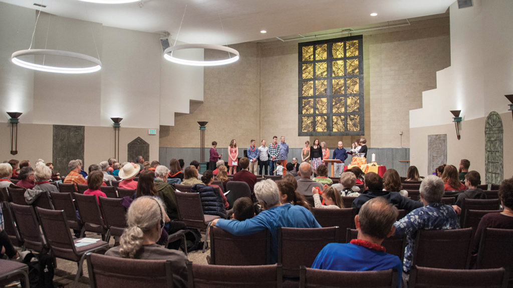Worshipers gather in the Seattle Mennonite Church sanctuary, originally a movie theater. — Seattle Mennonite Church