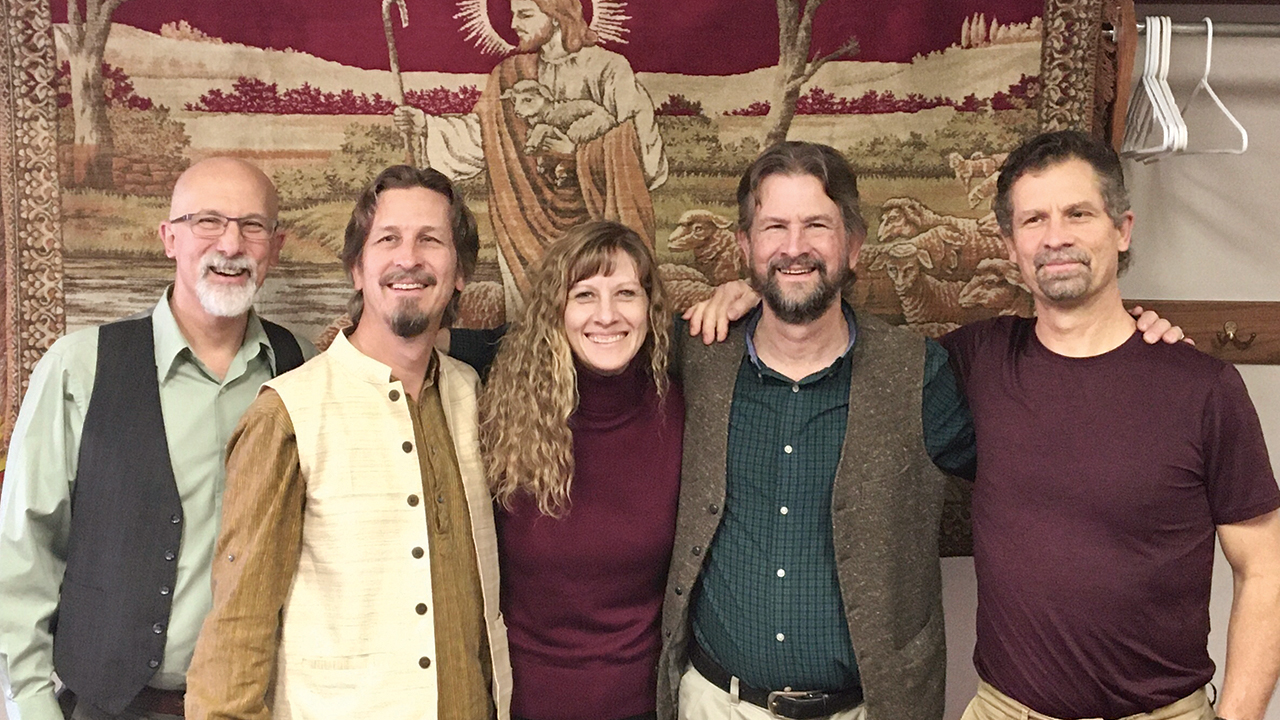Julie Reimer with brothers Stan, Ron, Brad and Daniel and the Russian tapestry their parents, Herb and Ruth Friesen, bought in Afghanistan more than 30 years ago. — Stan Friesen