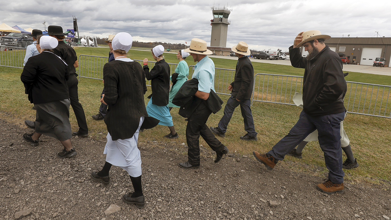 An Amish group from Punxsutawney, Pa., arrives at a Nov. 5 election rally with former President Donald Trump and candidates Doug Mastriano and Mehmet Oz in Latrobe, Pa. — Jacqueline Larma/AP