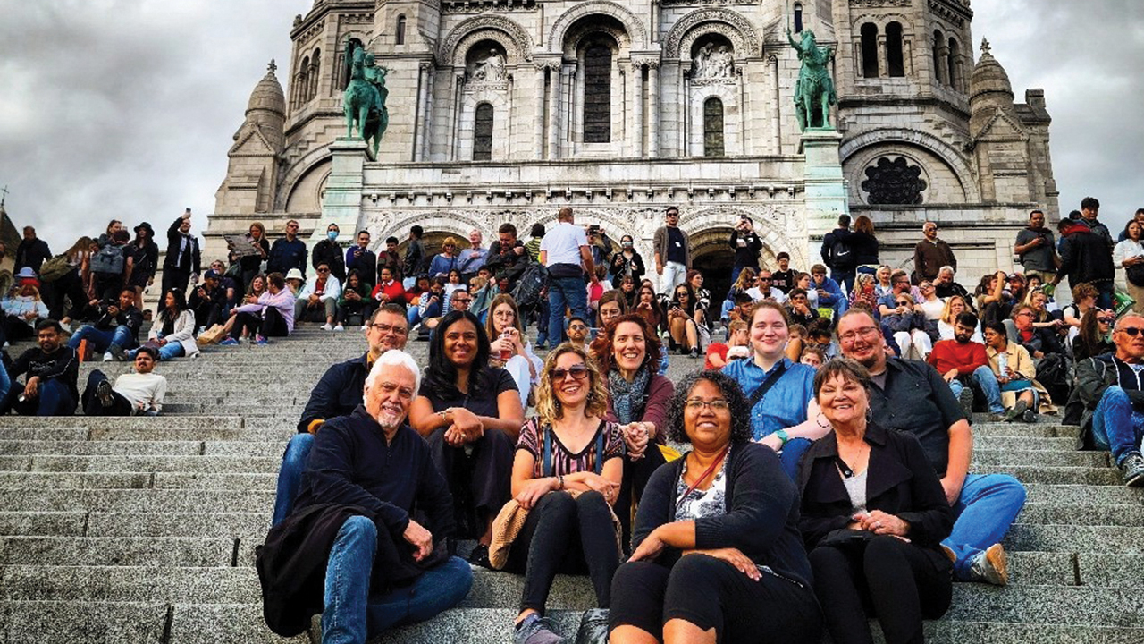 Participants in a Mennonite Mission Network visit to Paris gather in front of the Sacre Coeur (Sacred Heart), one of the most frequented tourist sites in Paris and an active Catholic church. From left are Matthew Krabill, James Krabill, Toni Krabill, Kayci Detweiler, Paula Snyder Belousek, Marisa Smucker, Erin Unruh, Jeanette Krabill and Hank Unruh. — Mennonite Mission Network
