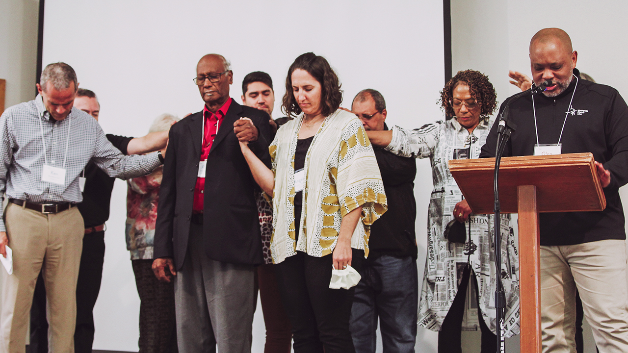 Mosaic Mennonite Conference incoming moderator Angela Moyer Walter and incoming assistant moderator Roy Williams are prayed for by a group including Mennonite Church USA executive director Glen Guyton, right, Nov. 5 at the conference's assembly. — Cindy Angela/Mosaic Mennonite Conference