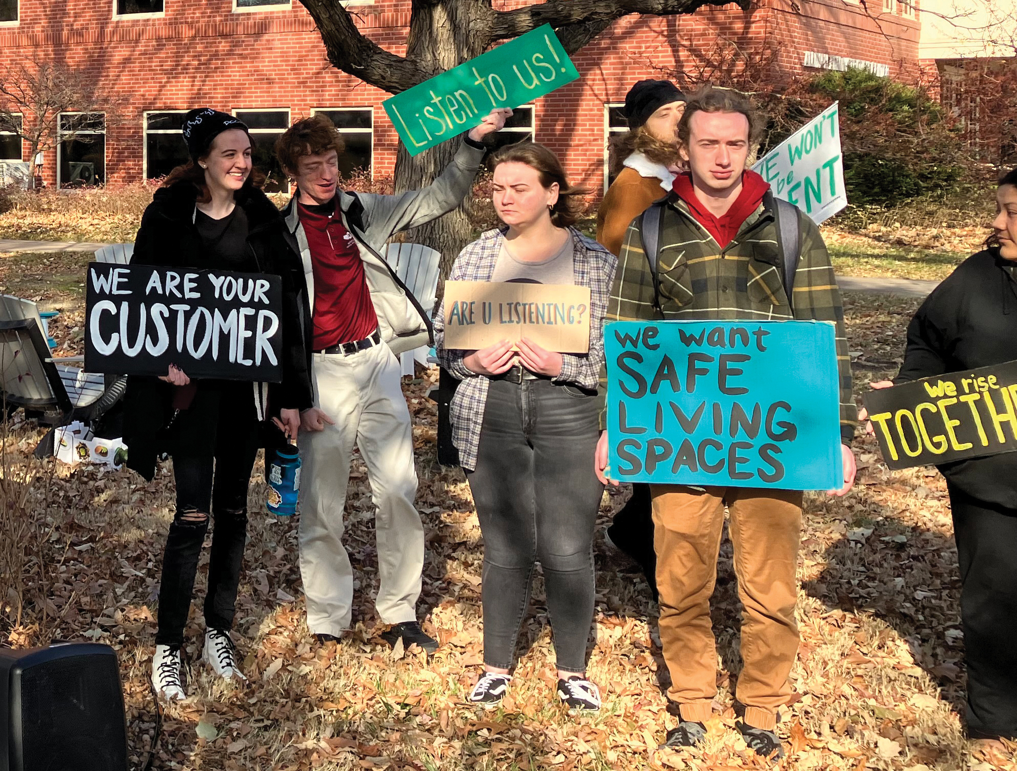 Hesston College students hold signs after walking out of Formation (chapel) on Dec. 2 to protest the college’s handling of sexual violence cases. — Paul Schrag/AW