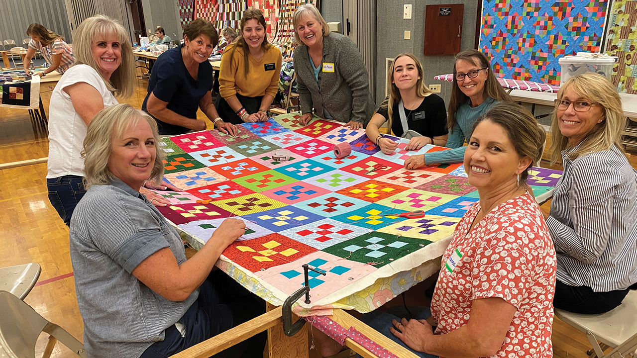 Women from the Eagle Stake Relief Society and the Knotty Ladies of Hyde Park Mennonite Fellowship in Boise, Idaho, gathered to knot comforters for Mennonite Central Committee. — Trina Tadje