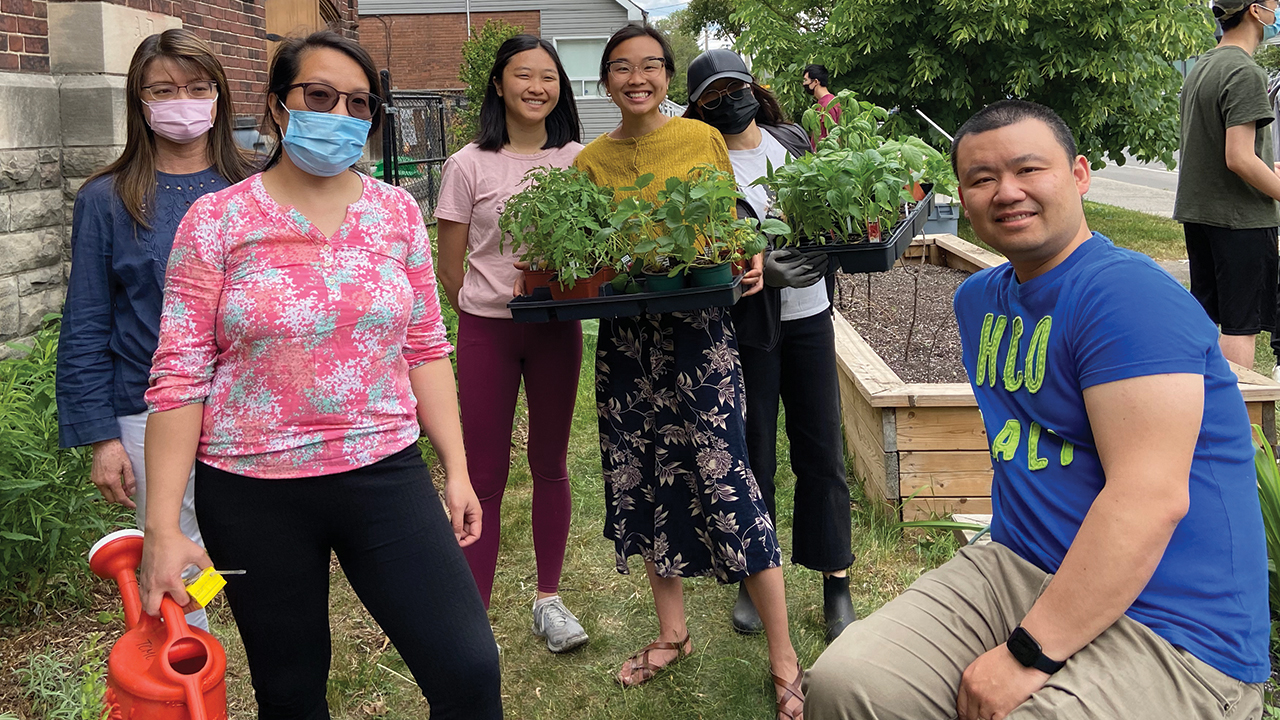 Members of Toronto Chinese Mennonite Church plant pollinator-friendly plants in raised beds outside the church. — Toronto Chinese Mennonite Church