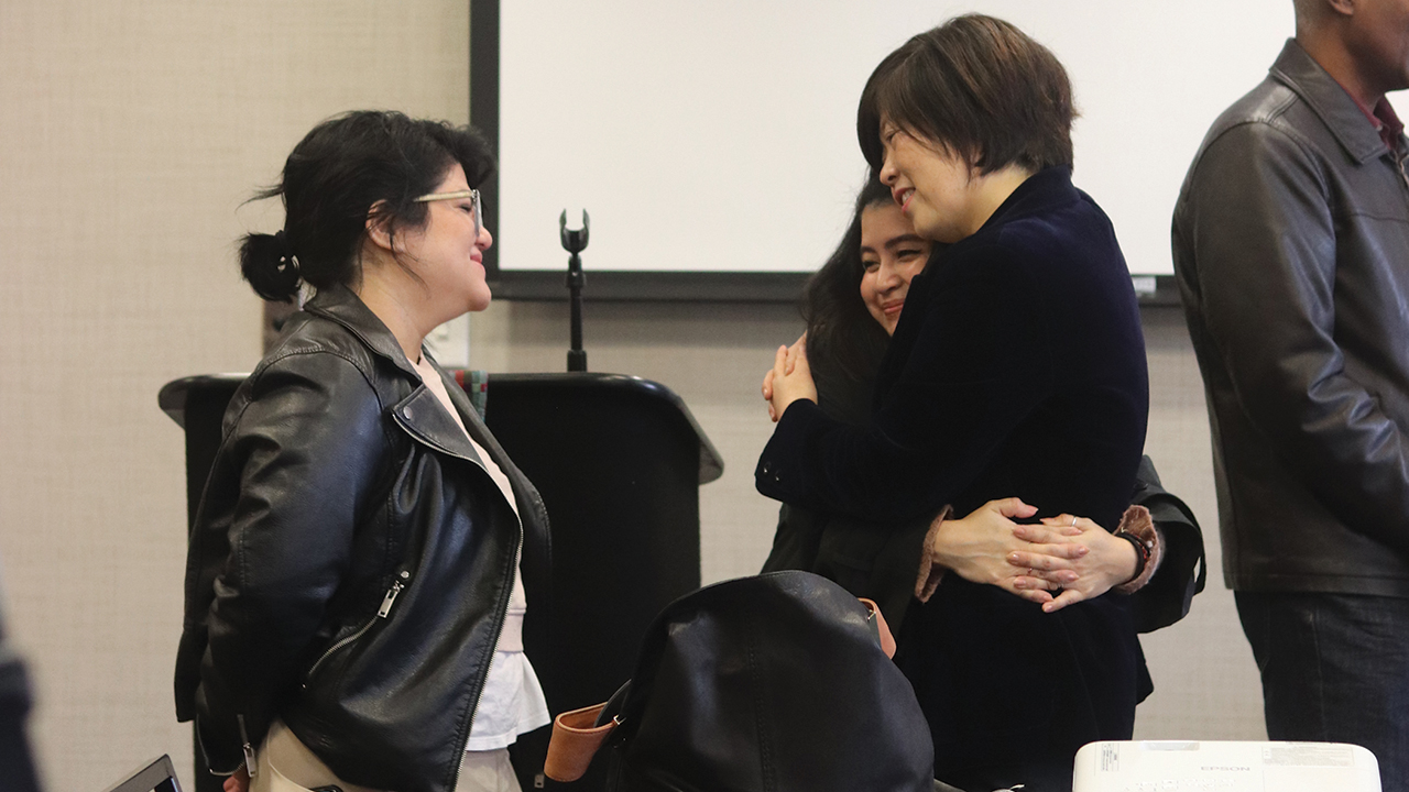 Daniela Lazaro-Manalo hugs Sue Park-Hur, right, as Myriam Johnstone looks on, at the close of the Hope for the Future conference. — Lynn Hur/MC USA