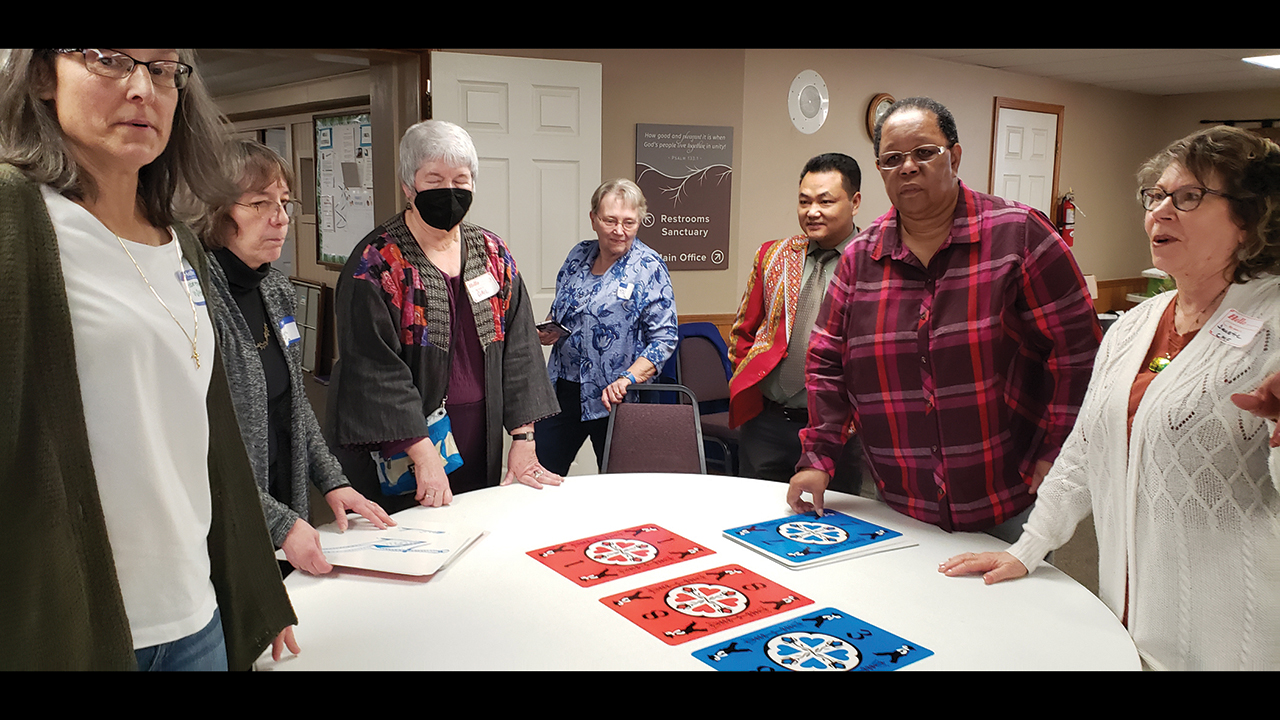 New York Mennonite Conference delegates discuss how they can work together in conference life and Dutch Blitz on Feb. 11 at Clarence Center-Akron Mennonite Church. — Carol Knieriem