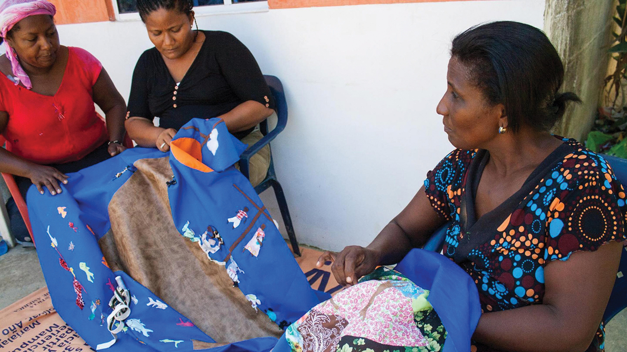 Juana Alicia Ruíz Hernández and Alexandra Valdez Tijera of Mampuján, Colombia, illustrate their experiences with violence on quilts after women in the community talked about the violence they and their ancestors had experienced. — Anna Vogt/MCC