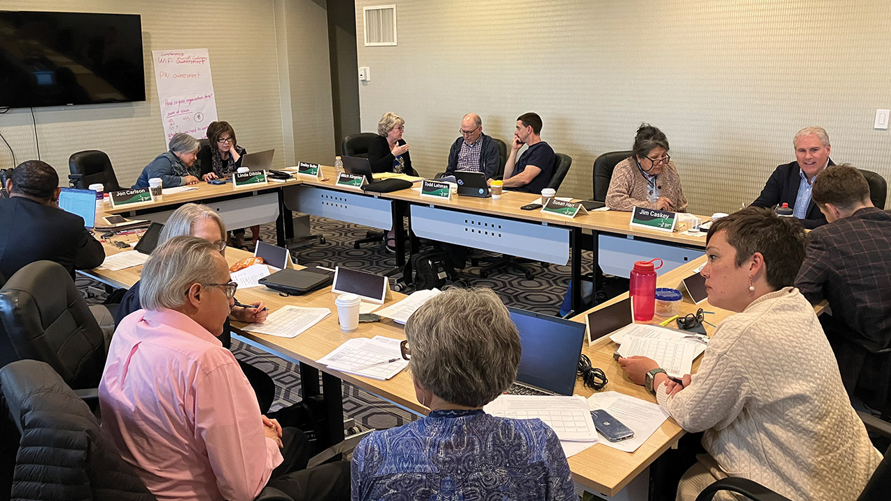Members of the Mennonite Church USA Executive Board talk in small groups on April 13 in Los Angeles. — Paul Schrag/AW