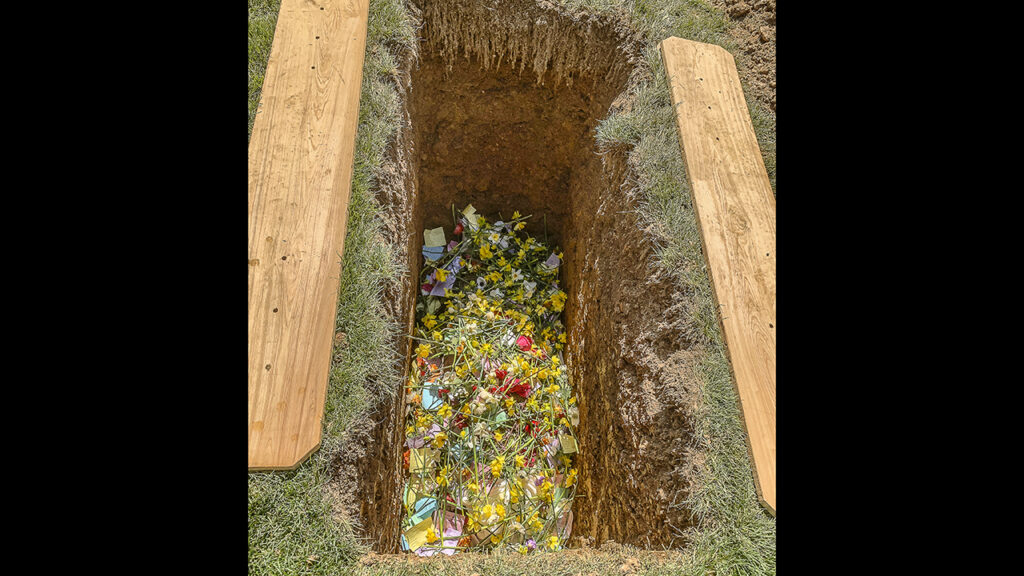 Flowers and notes of blessing and remembrance from guests blanketed Priscilla Ziegler’s shrouded body. — Lloyd Chapman