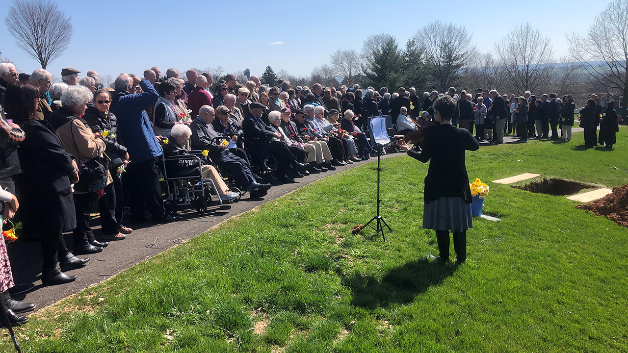 Charity Shenk plays viola as guests await the arrival of Priscilla Ziegler’s immediate family for the graveside service in the cemetery on March 29 at Akron Mennonite Church in Pennsylvania. — Jim Shenk