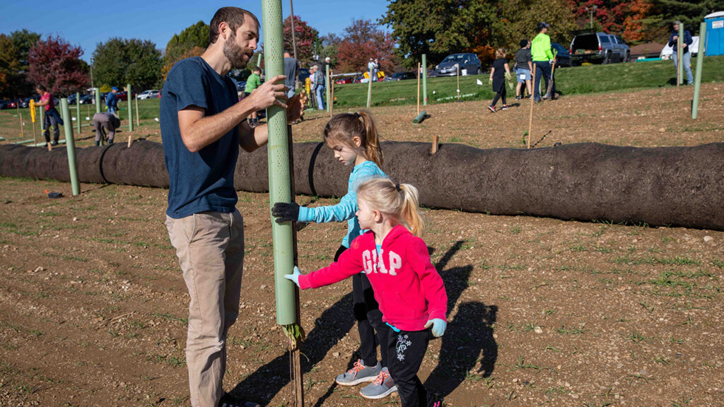 Nick, Abby and Lily Buckwalter joined 150 people who planted 450 tree seedlings in October at Akron Mennonite Church in Pennsylvania. — Bob Wyble