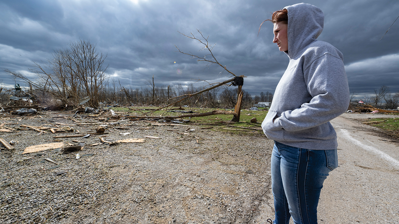 Jaycee Ahlefeld surveys the damage left after a late-night tornado devastated the area in Sullivan, Ind., April 1. — Doug McSchooler/AP