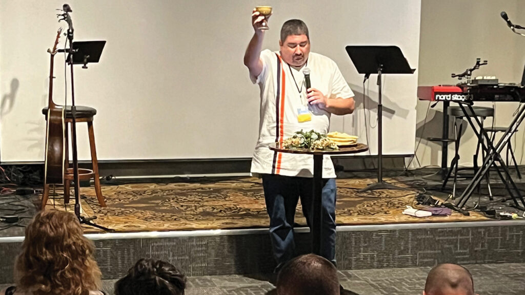 Evana Network executive director Matt Hamsher leads communion in February at Flourish. — Evana Network