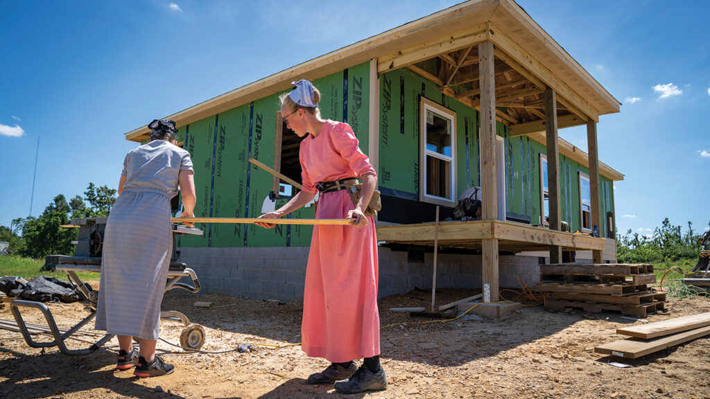 Volunteers Carrie Mast, right, and Roseanne Helmuth of Nappanee, Ind., with Mennonite Disaster Service and Acknowledging Christ Through Service, rebuild homes in May 2022 in Mayfield, Ky., after a Dec. 10, 2021, tornado. — Paul Hunt/MDS