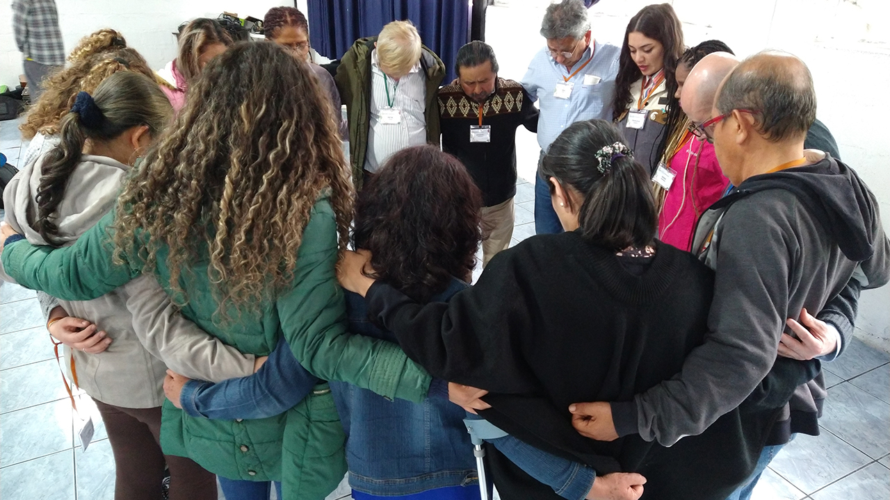 Participants from nine Anabaptist conferences pray at a gathering in February in Quito, Ecuador. — Linda Shelly/MMN