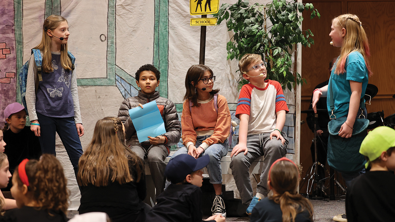 Schoolchildren try to figure out the mission left for them in an anonymous note during the performance of Mission Possible: Sharing the Gospel by Our Love on March 12 at Silverwood Mennonite Church in Goshen, Ind. — Jason Potsander