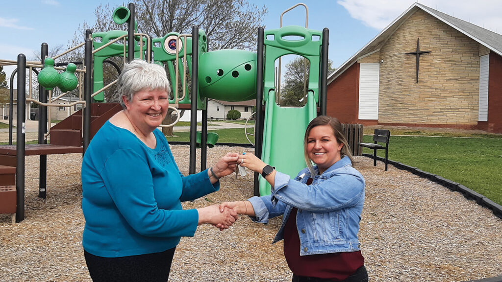 Trinity Pastor Norma Duerksen gives the church keys to Tristen Cope, chair of the Hillsboro Community Foundation. — Laurie Oswald Robinson