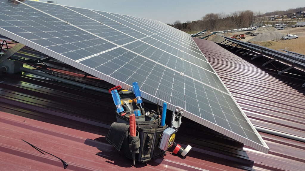Three rows of solar panels sit on the roof of Wellspring Components near Shipshewana, Ind. — Wellspring Components