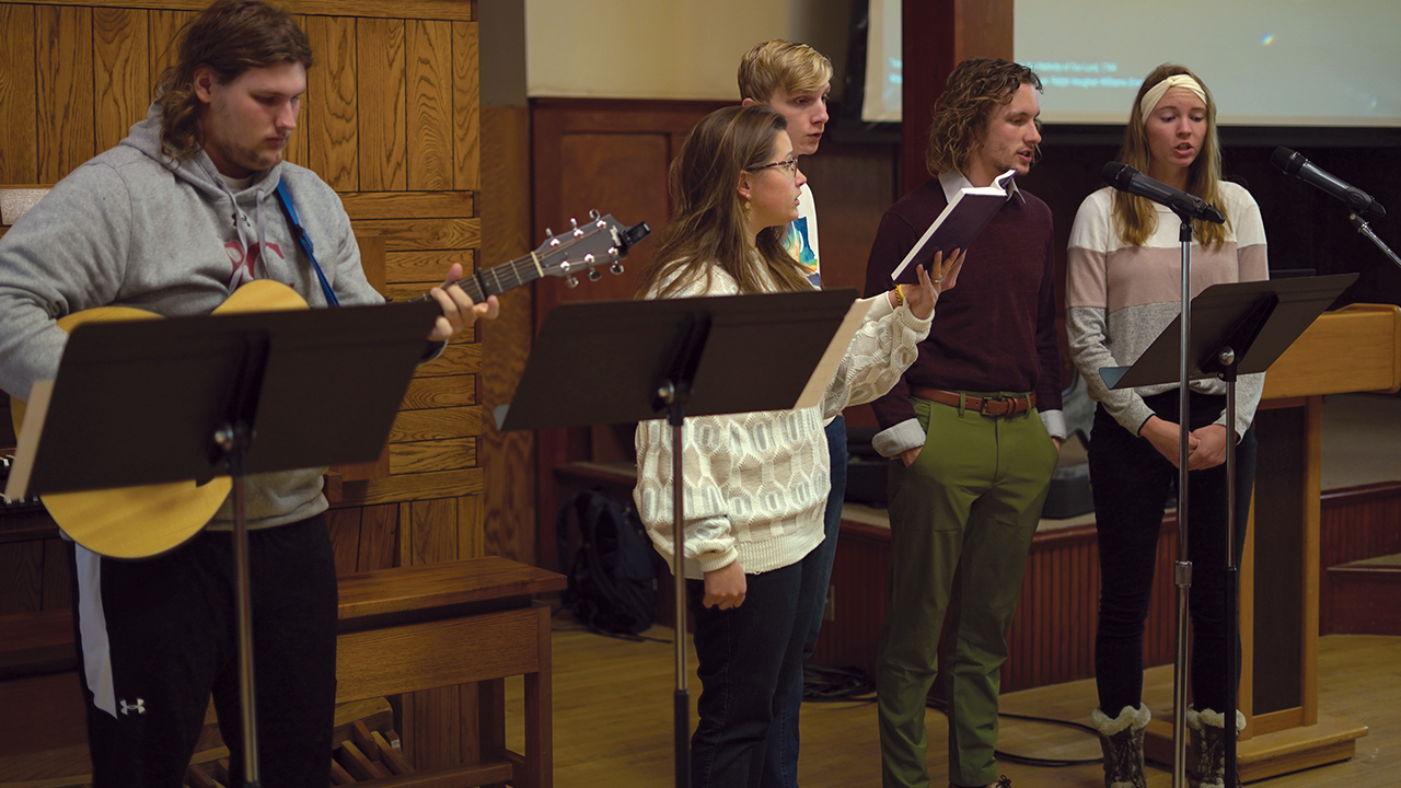 Bethel College students Rachel Geyer, Peter Buller, Seth Rudeen and Stephany Meyer lead singing during a chapel service in November. — Chase Dempsey/Bethel College