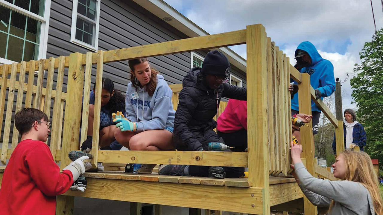 Eastern Mennonite School students build a porch in April on a house constructed by Mennonite Disaster Service in Hurley, Va., following flooding and mudslides that destroyed 60 homes and damaged 200 others in 2021. — Eastern Mennonite School