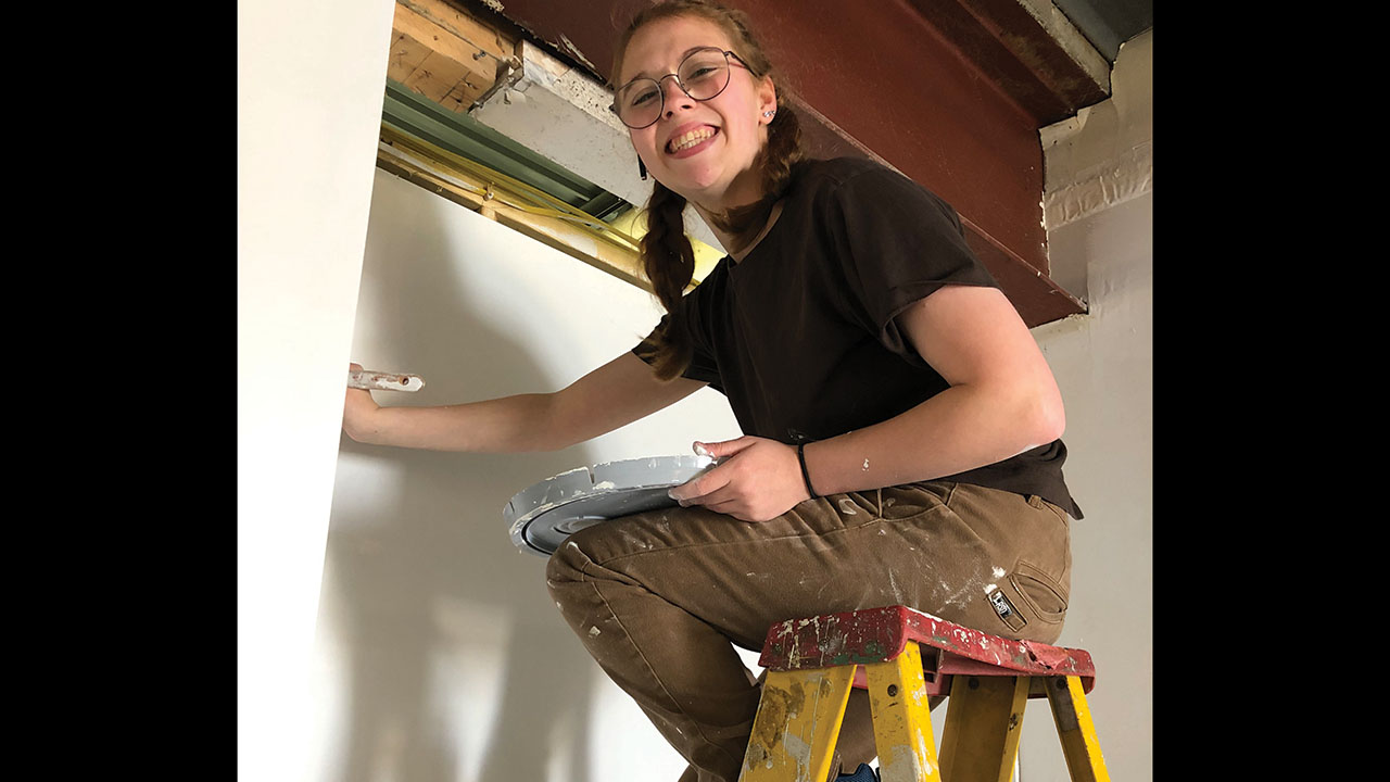 Goshen College student Cameron Comadoll paints in an old grocery store that will be the MDS center of operations in Red Lake, Minn. — John Longhurst/MDS