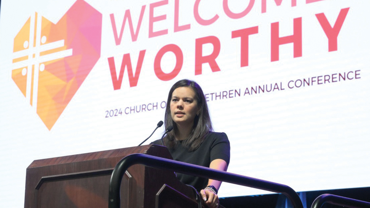 Madalyn Metzger, moderator of the Church of the Brethren annual conference for 2024, introduces the denomination’s 2024 theme July 8 at closing worship. — Glenn Riegel/Church of the Brethren