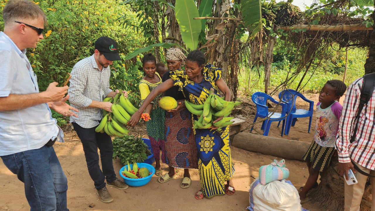 Paraguayan Mennonites look over fruit during a visit to investigate the possibility of purchasing land for a settlement in the Democratic Republic of Congo. — Peter Neudorf