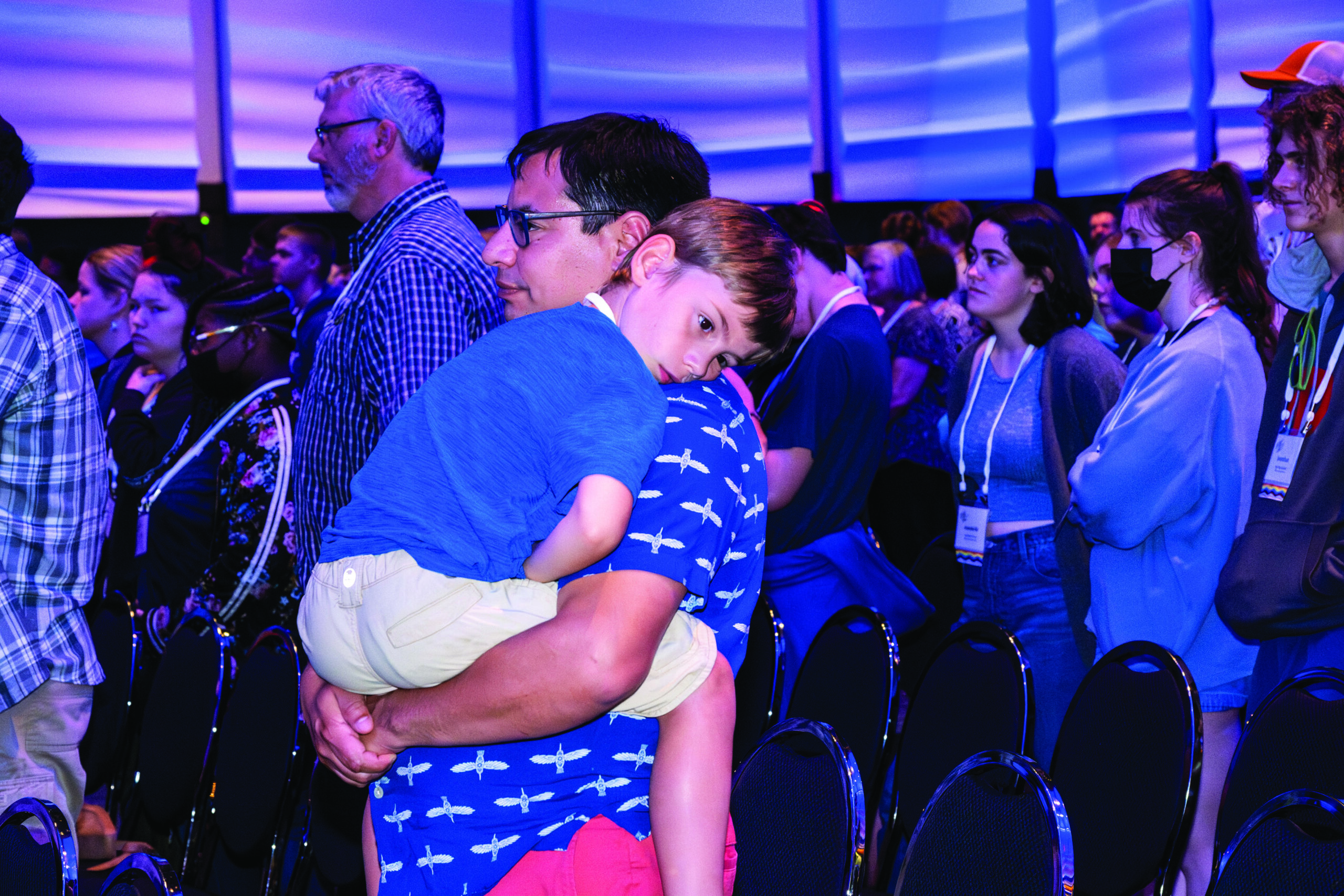Nata Fontan holding Frankie Fontan at a MennoCon23 worship. - Mennonite Church USA