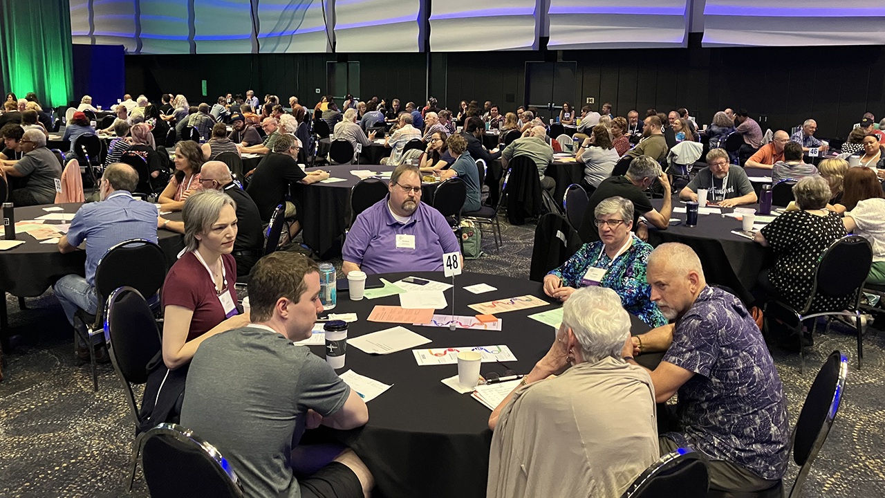 Mennonite Church USA delegates meet in table groups on July 8 in Kansas City, Mo. — Paul Schrag/AW
