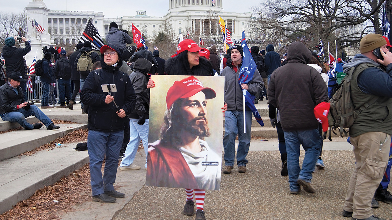 A person carries a picture of Jesus wearing a Make America Great Again hat at the Jan. 6, 2021, insurrection at the U.S. Capitol. — Tyler Merbler/Flickr/Creative Commons