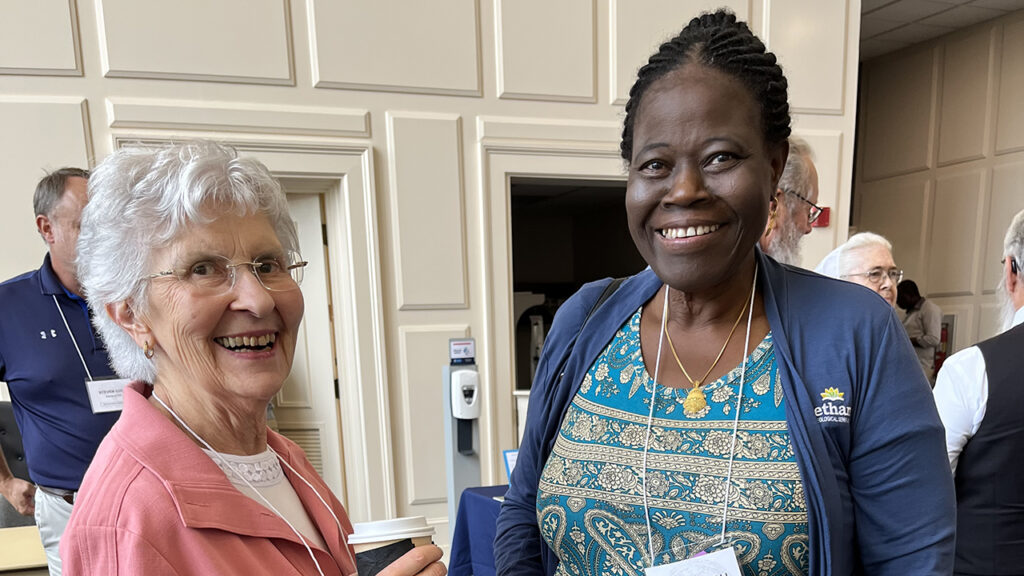 Theresa Eshbach, left, a Church of the Brethren member from Mechanicsburg, Pa., reconnects with Rebecca Dali. A native of Nigeria, Dali is co-pastor of Panther Creek Church of the Brethren outside Des Moines, Iowa. — Steven Nolt/Young Center for Anabaptist and Pietist Studies
