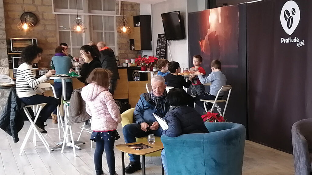 Adults and children gather at Prai’lude Café, a cafe and bookstore that opened at Montbéliard Prairie Church in 2021. — Raymonde Klopfenstein