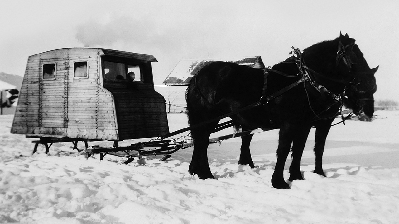 Enclosed sleighs known as cabooses were used for winter transportation in Canada in the 1940s. They often had a small wood stove inside for warmth. This caboose was built by Ben B. and John H. Peters. — La Crete Mennonite Heritage Village